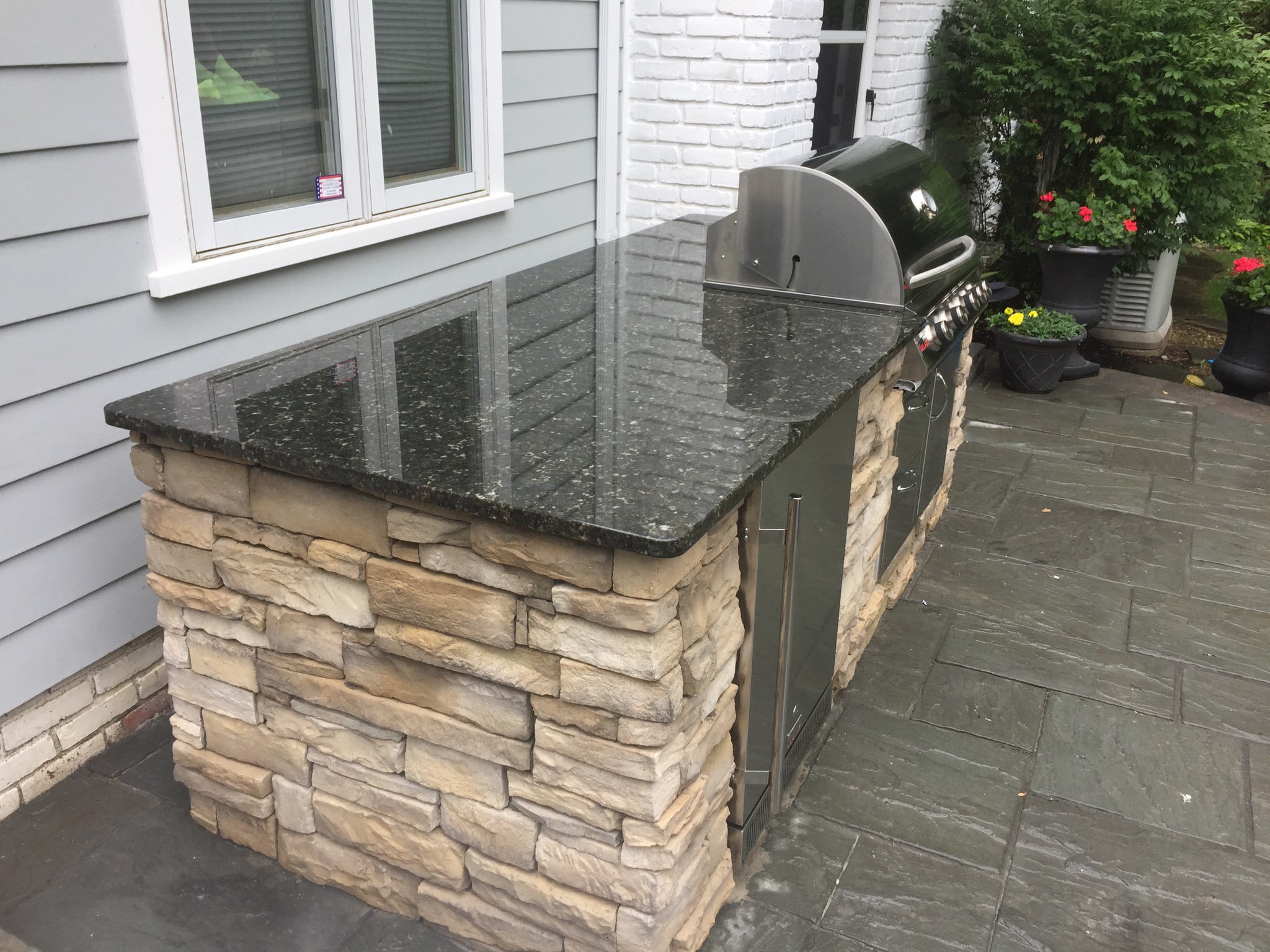 stone encased outdoor grill on a patio